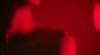 a blurry image of a woman's face in red light