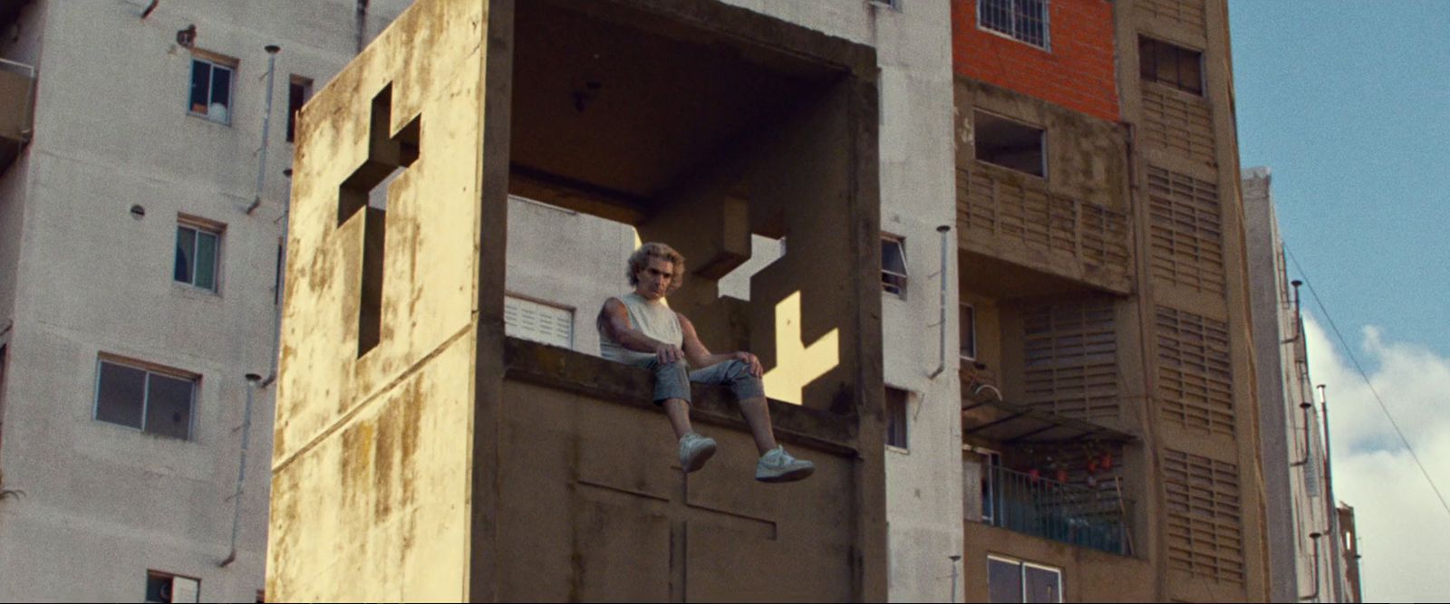 a person sitting on a ledge of a building