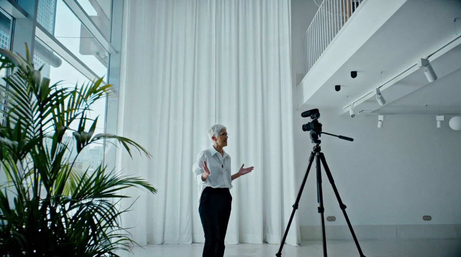 a woman is standing in front of a camera