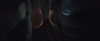 two people holding hands in the dark