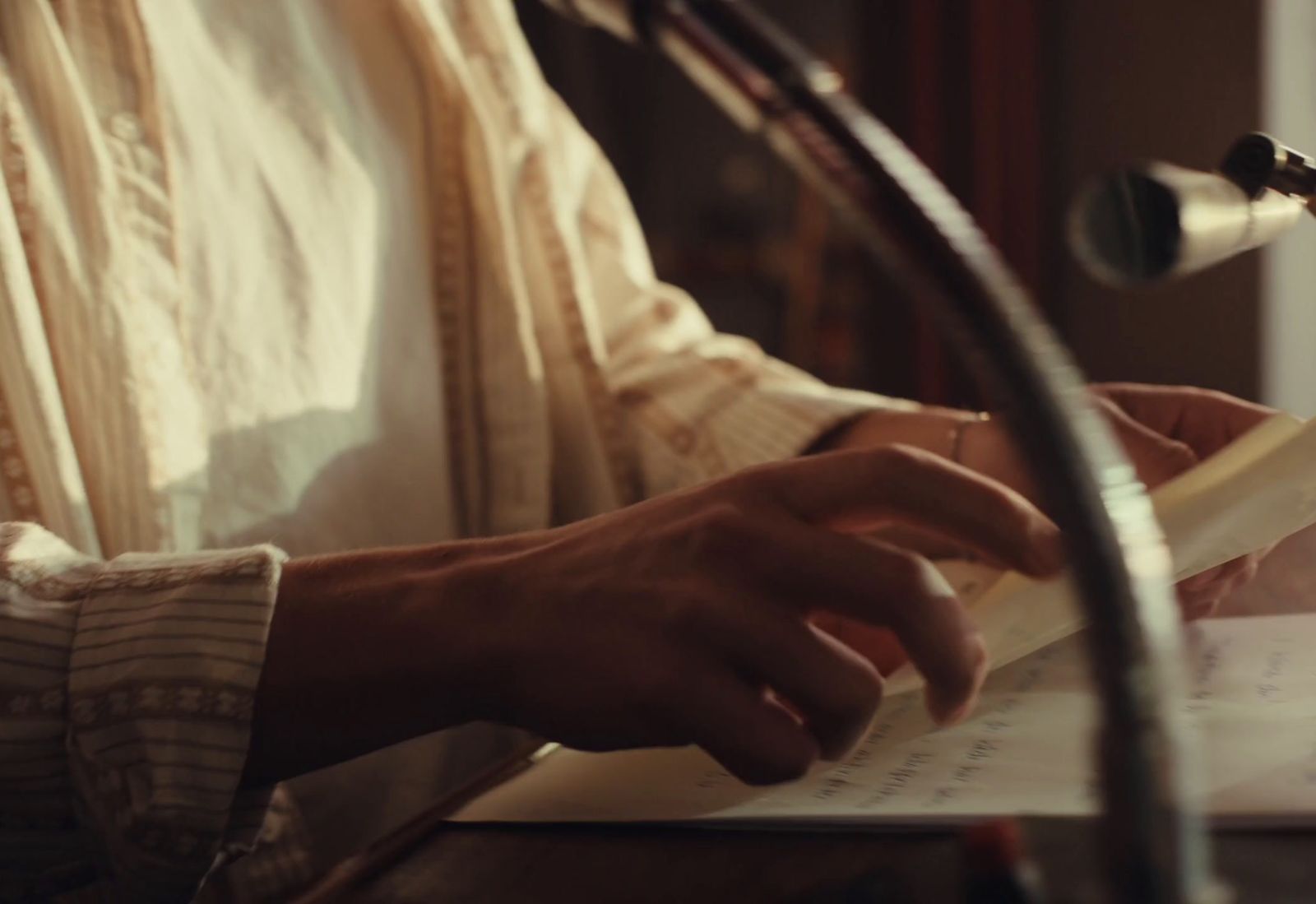 a close up of a person writing on a piece of paper