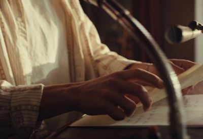 a close up of a person writing on a piece of paper