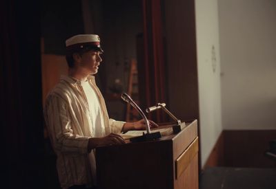 a man standing at a podium in front of a microphone