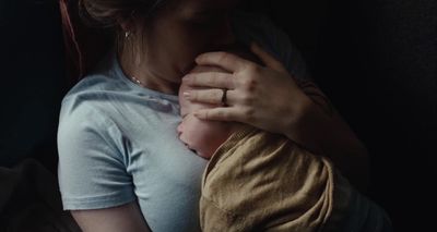 a woman holding a baby in her arms