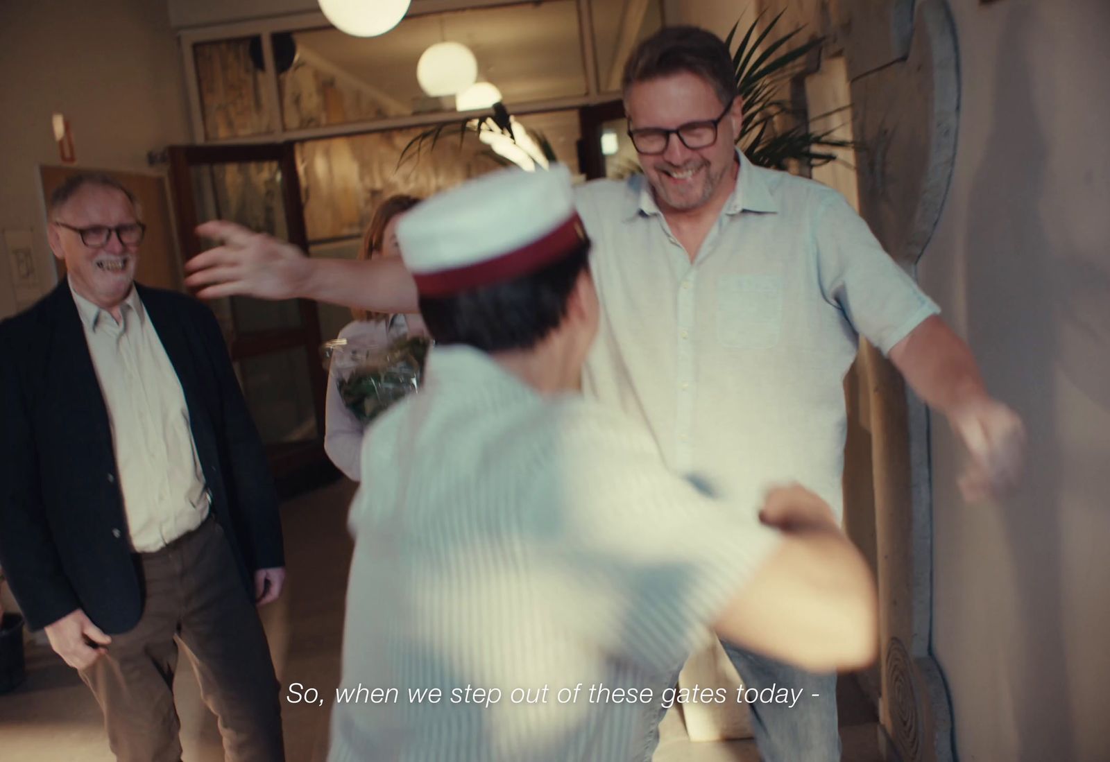 a group of men standing around each other in a room