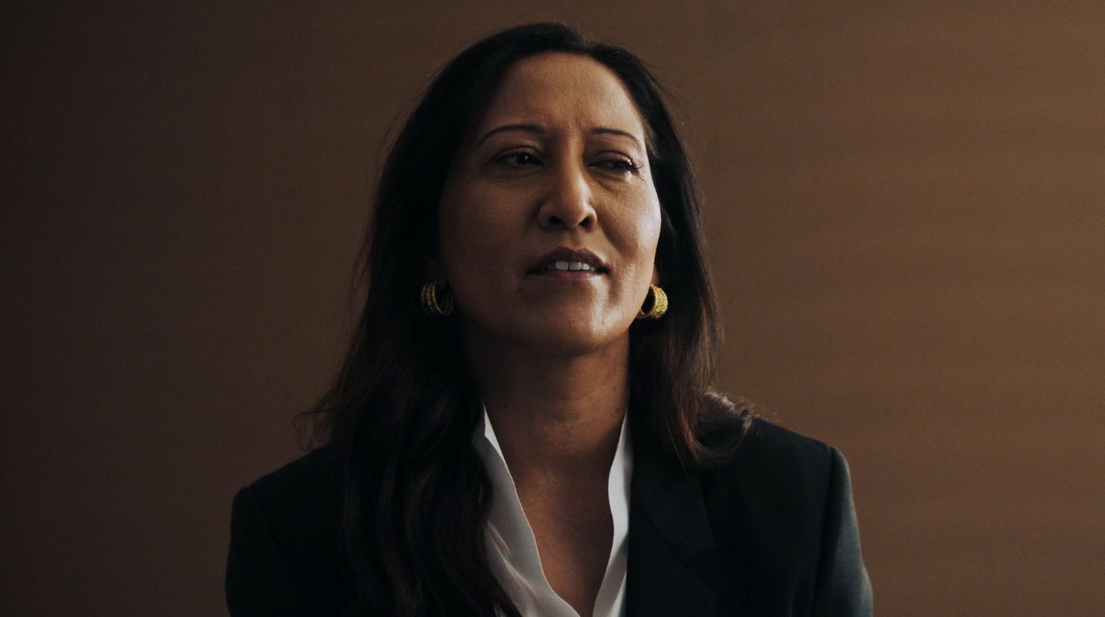 a woman in a black jacket and white shirt