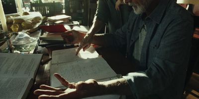 a man sitting at a table with a lot of papers