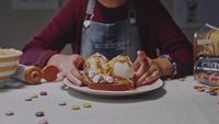 a person sitting at a table with a plate of food