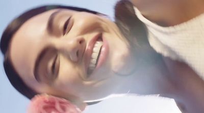 a close up of a person with a flower in his hair