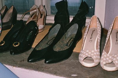 a group of women's shoes lined up on a window sill