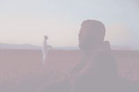 a blurry image of a person standing in a field