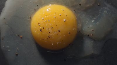 an egg is fried in a frying pan