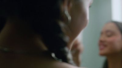 a woman brushing her teeth in front of a mirror