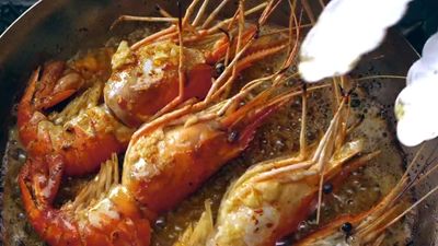 a close up of a pan of food with shrimp