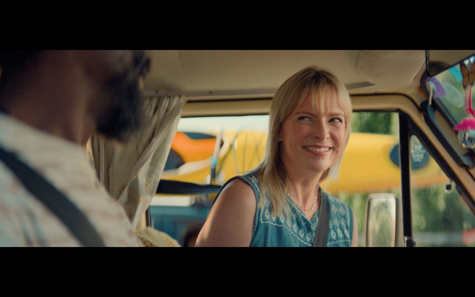 a woman sitting in the passenger seat of a car