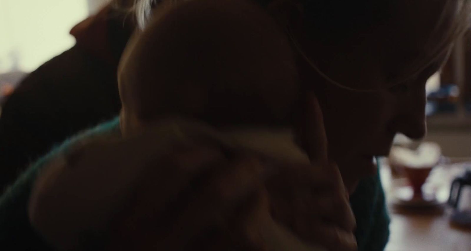 a woman holding a baby in her arms