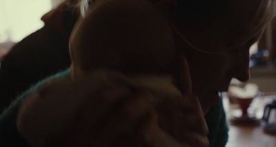 a woman holding a baby in her arms