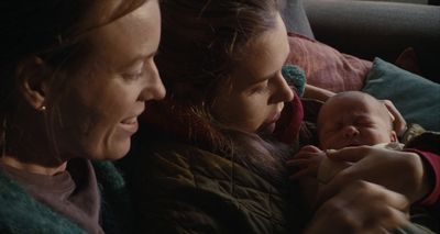 a woman holding a baby in her arms