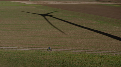 a person riding a bike in a large field