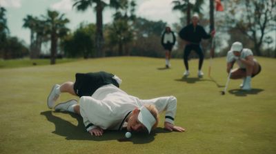 a group of people playing a game of golf