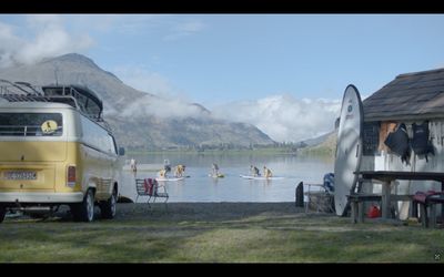 a van parked next to a body of water