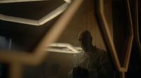 a man in a white shirt standing in a room