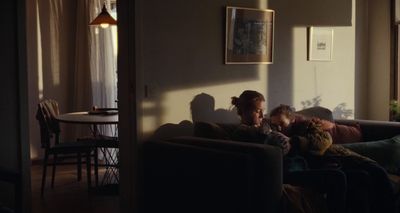 a group of people sitting on a couch in a living room