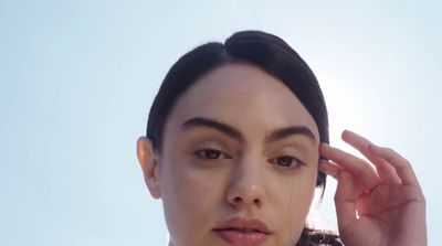 a close up of a person holding a cell phone to their ear