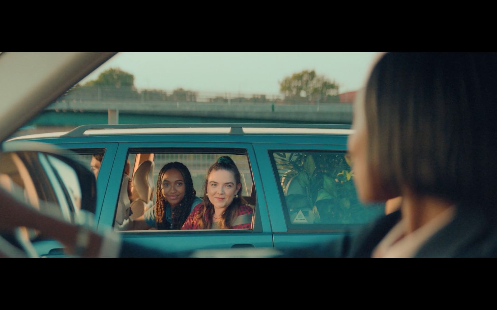 two women sitting in the back seat of a car