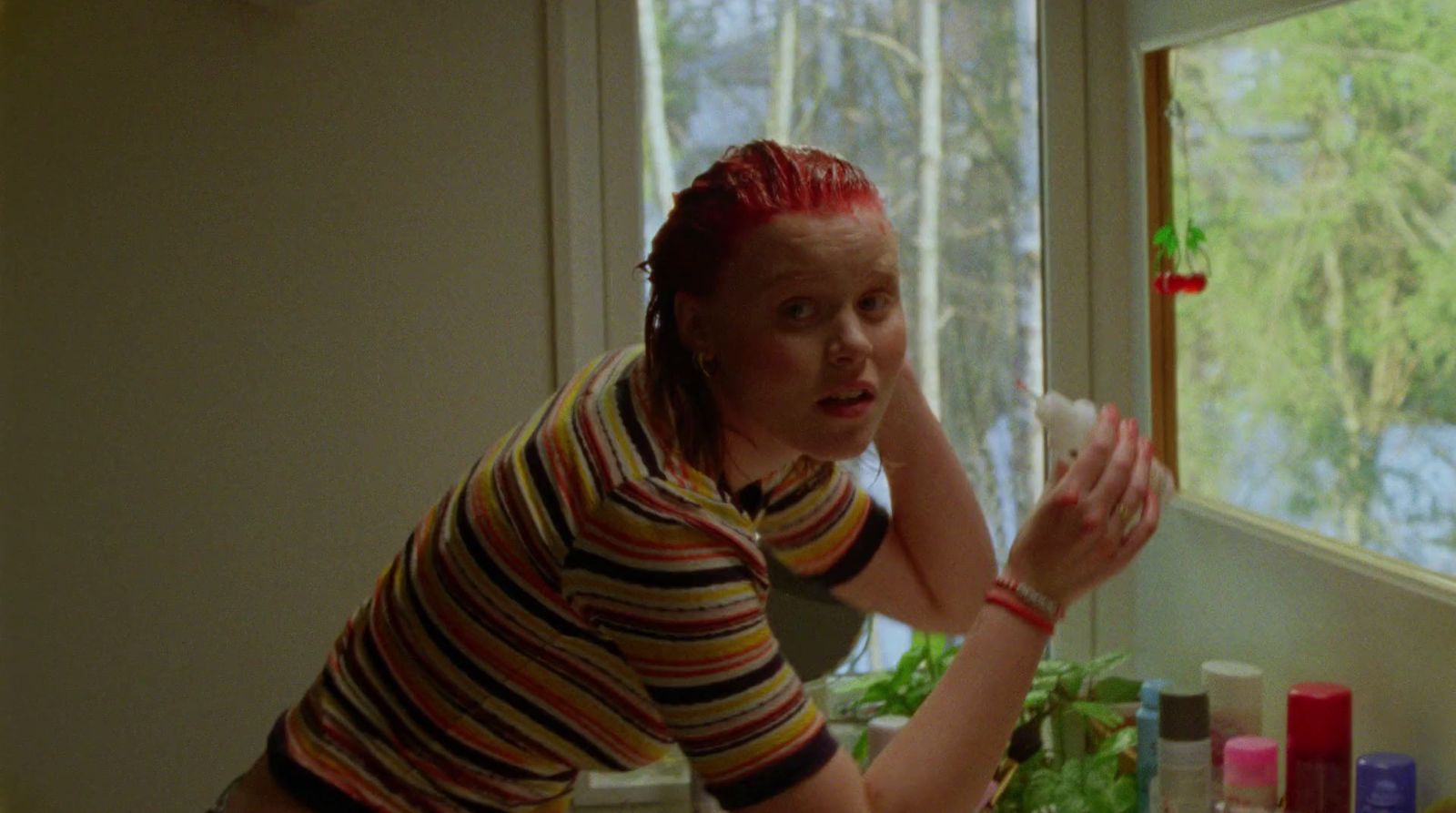 a woman with red hair is looking at something