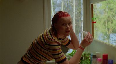 a woman with red hair is looking at something