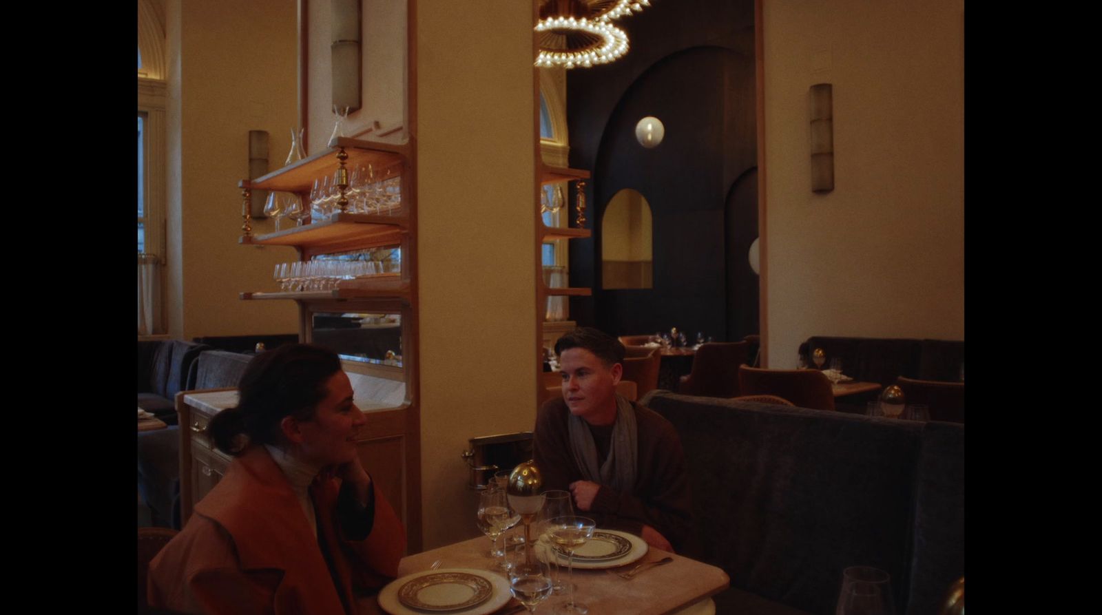 two people sitting at a table in a restaurant