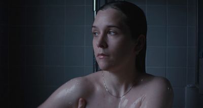 a woman in a shower with no shirt on