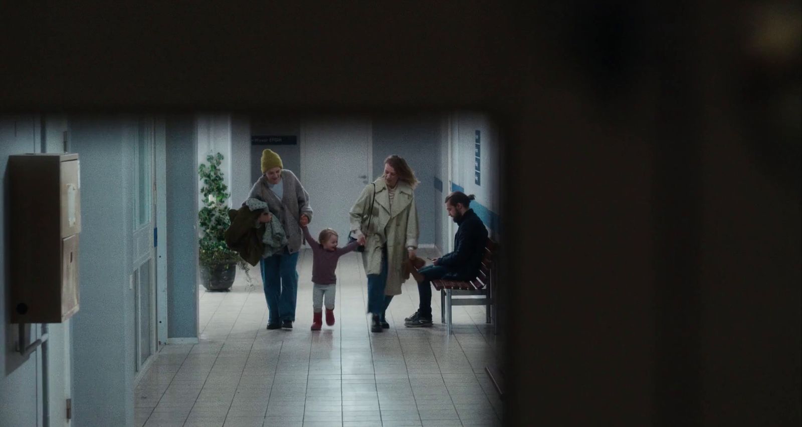 a group of people walking down a hallway