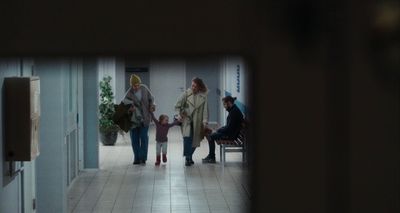a group of people walking down a hallway