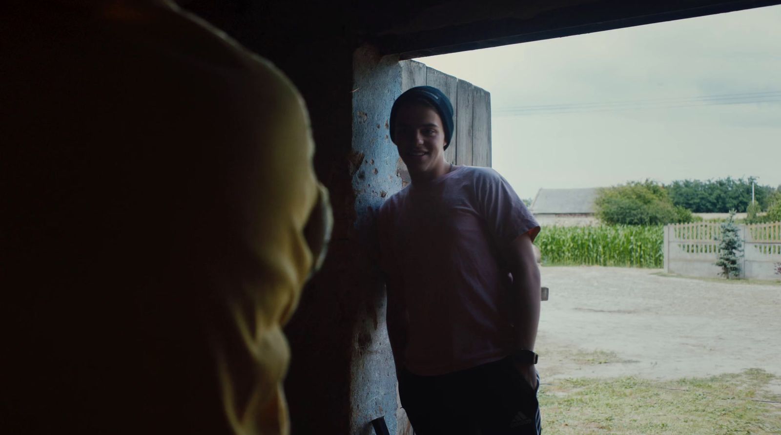 a man standing in front of a barn door