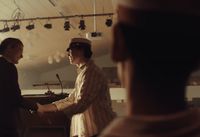 a man shaking another mans hand in a room