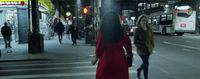 a woman in a red dress is crossing the street