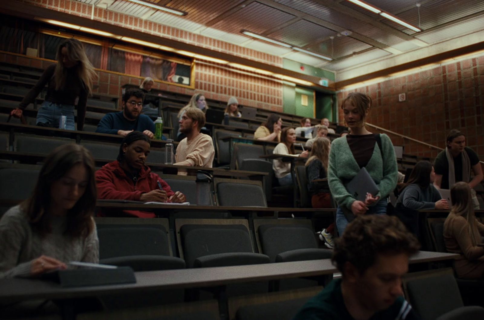 a group of people sitting in a lecture hall