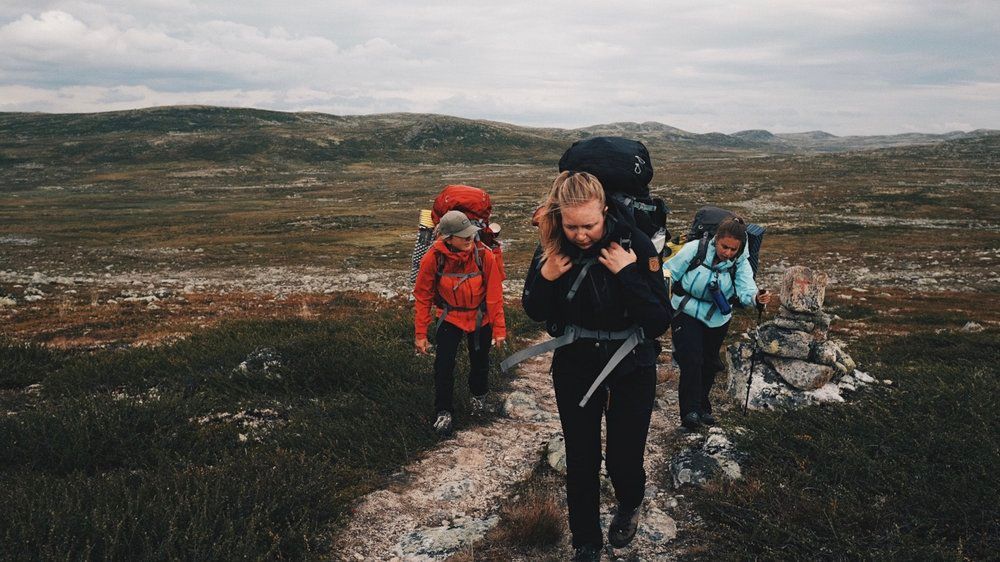 a group of people walking up a hill