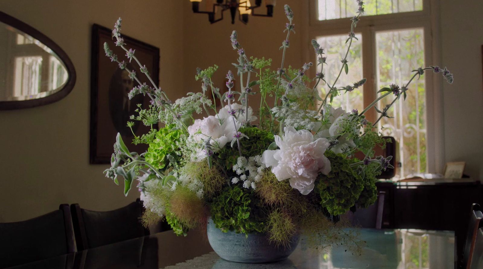 a vase filled with flowers sitting on top of a table