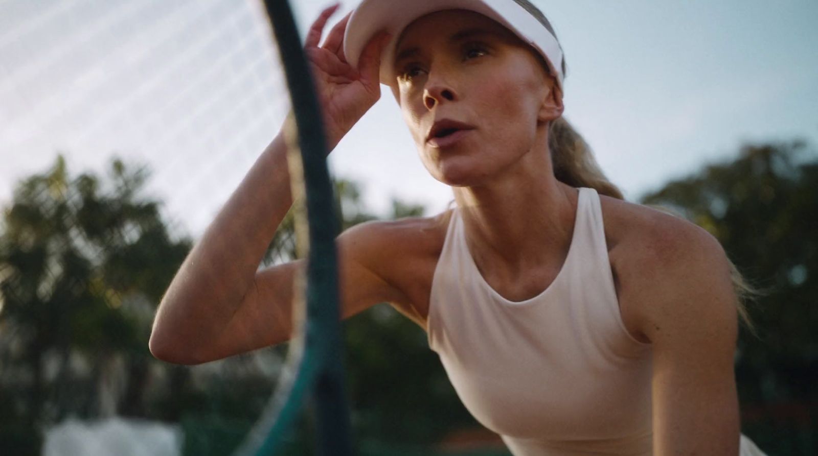 a woman holding a tennis racquet on a tennis court