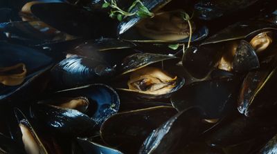 a pile of mussels sitting on top of a table