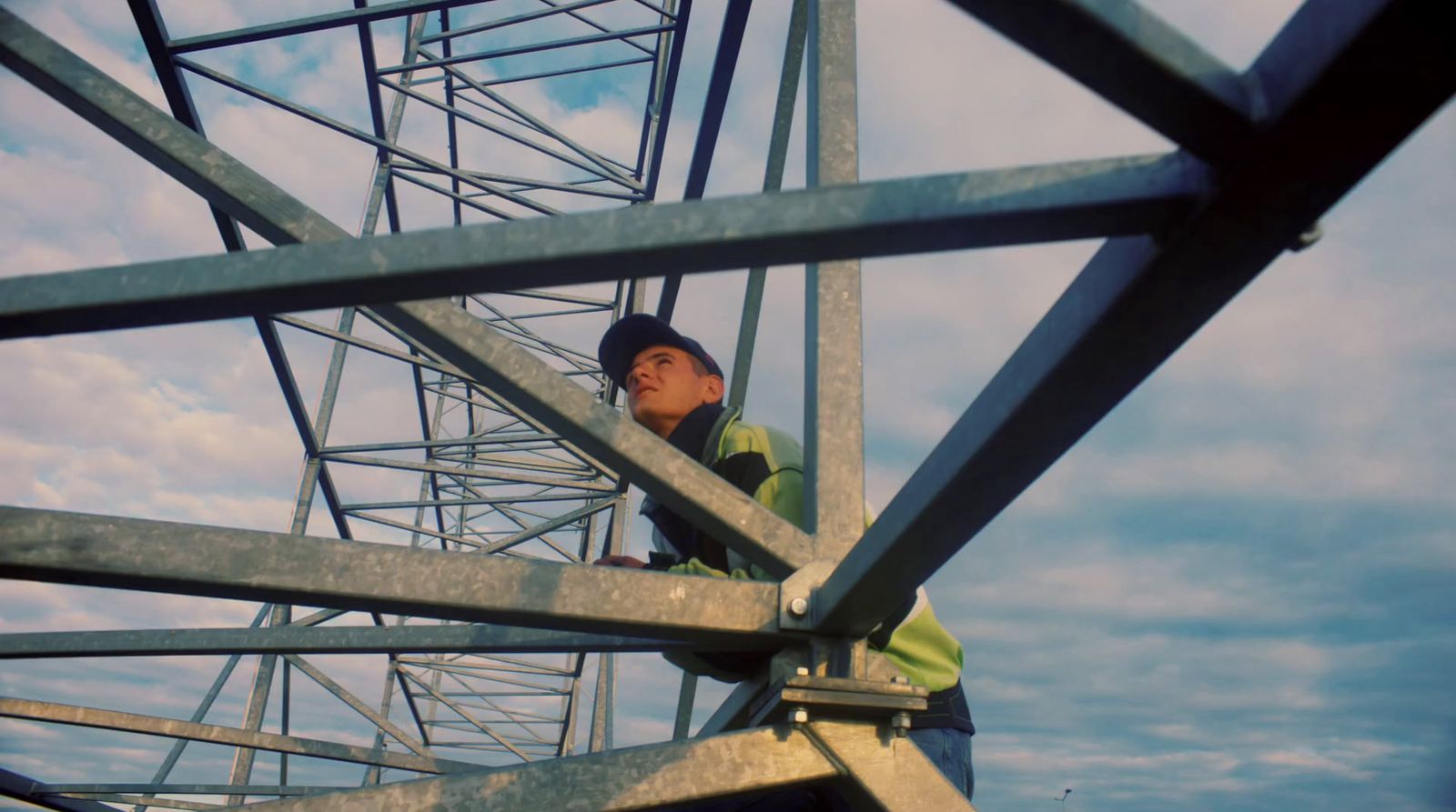 a man standing on top of a metal structure