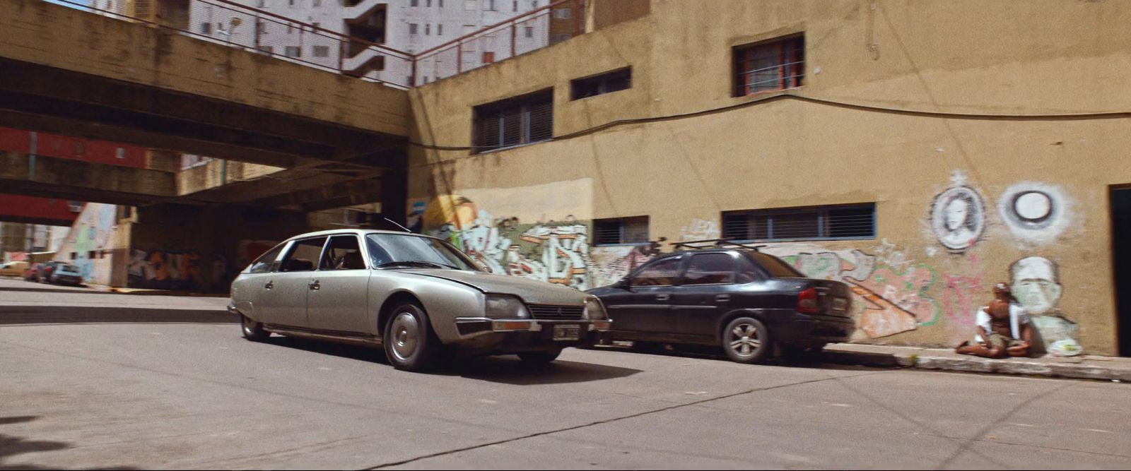 a couple of cars parked next to each other on a street