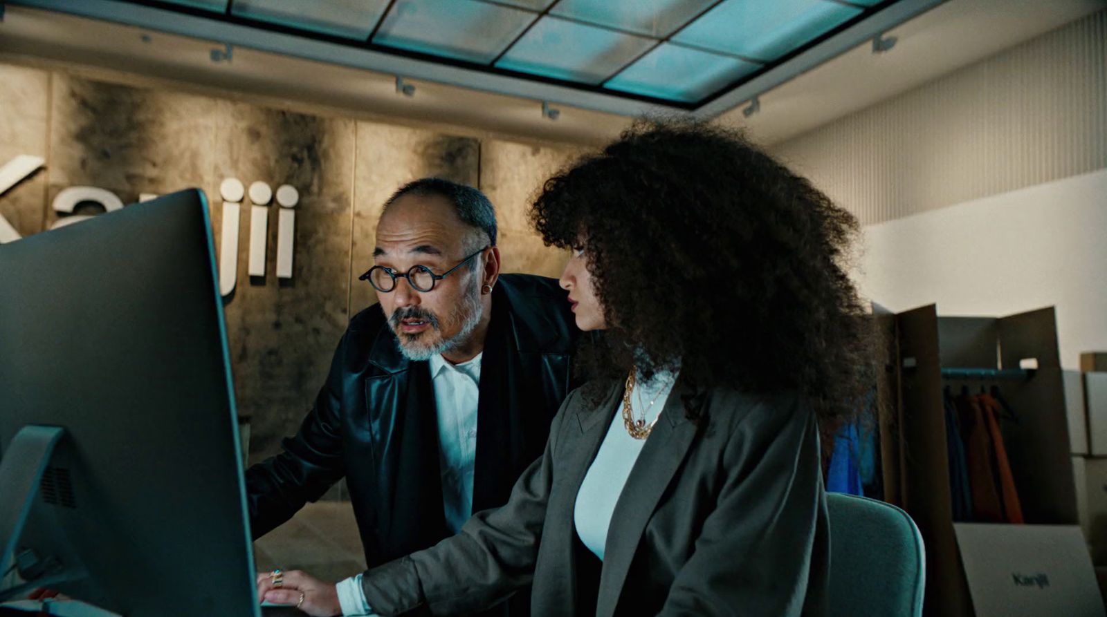 a man and a woman looking at a computer screen