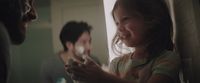 a little girl holding a nintendo wii game controller
