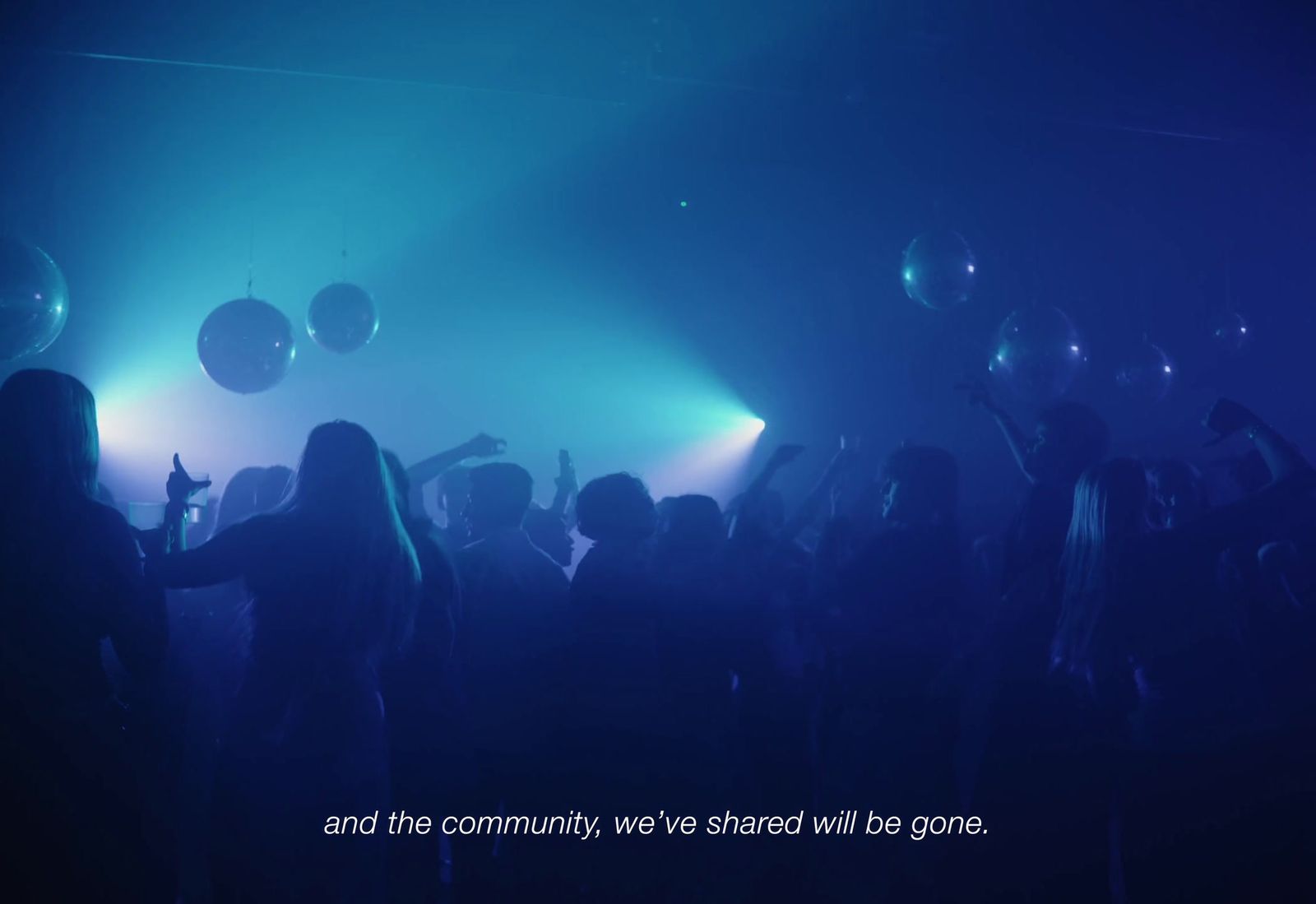 a group of people standing in a dark room