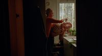 a woman standing next to a child in a kitchen