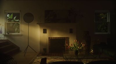 a dimly lit living room with a fireplace